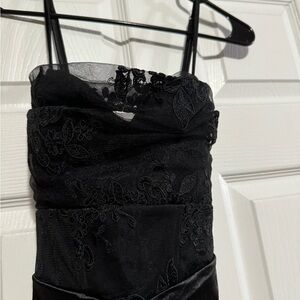Stunning black silky dress with lace back in size Medium.